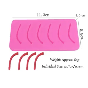 Macro shot of pink silicone suture training pad and red curved strips with dimensions
