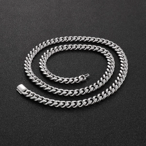 Close-up of hip hop silver Cuban link chain with square buckle on black background