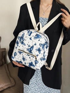 White butterfly printed backpack with blue constellations and adjustable straps