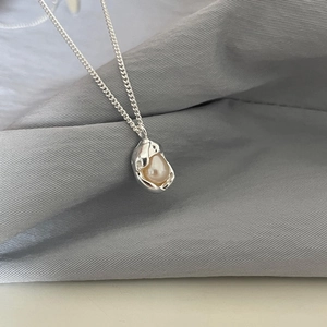S925 sterling silver necklace with pink freshwater pearl on grey textured backdrop