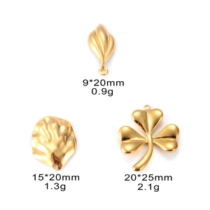 Detailed view of three gold leaf pendants in various sizes with weight specifications