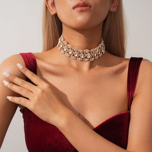 Detailed view of luxury gold choker with marquise rhinestones on velvet gown model