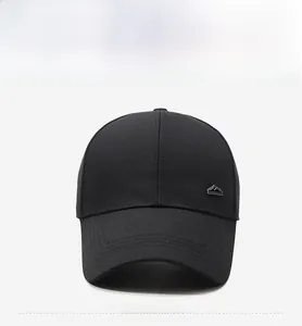 Close-up of black cotton baseball cap featuring a minimalist metal mountain peak logo
