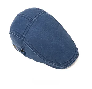 Top view of a classic dark blue denim flat cap with vintage washed texture and stitching