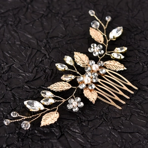 Detail of silver leaf hair comb featuring delicate white pearls and sparkling rhinestones