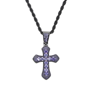 Macro shot of hip hop cross pendant with blue zircon stones on black metal chain