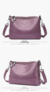 Detail of lavender snake-embossed leather texture and metal zipper on crossbody bag
