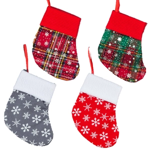 Set of four festive Christmas stockings with red and green plaid and snowflake patterns