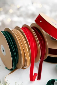 Close-up of assorted velvet ribbon rolls in festive colors for gift wrapping DIY