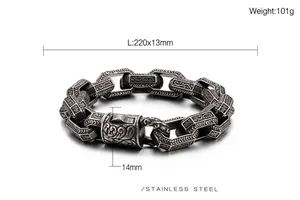 Macro detail of men's stainless steel curb bracelet with vintage floral carvings