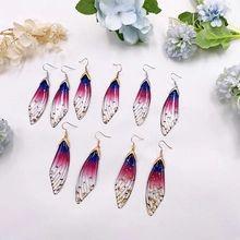 Detailed view of handmade S925 silver gradient cicada wing earrings with gold glitter accents