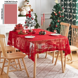 Detail of red Christmas lace tablecloth featuring festive house and snowflake patterns