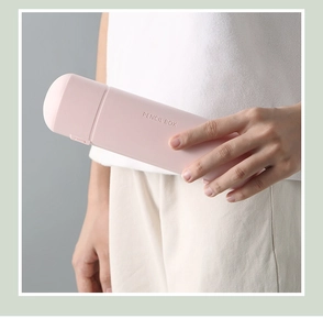 Close-up of hand holding a light pink matte minimalist pencil box for students