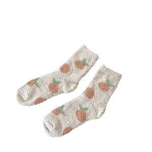 Thick coral fleece winter socks with orange fruit pattern on a beige background