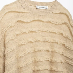 Beige mohair knit sweater with layered ruffle trim and round neck in retro style
