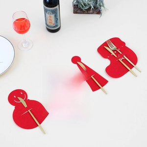 Felt Christmas cutlery holder set with snowman and tree shapes on holiday table