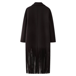 Detail view of black long wool coat featuring fashionable tassel design on the bottom hem