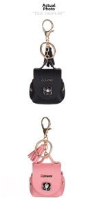 Close-up of faux leather earphone pouch keychain with camellia flower and pearl detail