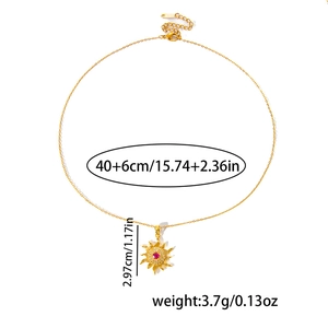 Detail view of gold sun pendant necklace with red stone, sizing and weight info