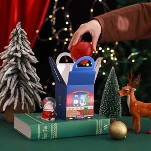 Blue Christmas gift box with handle featuring festive illustrations on a dark background
