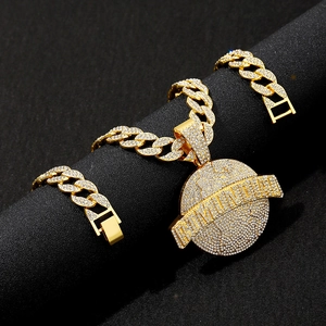 Close-up of golden hip hop Cuban necklace with iced-out round pendant on dark stand