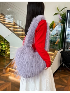Detailed view of the lavender faux fur shoulder bag worn with a casual outfit