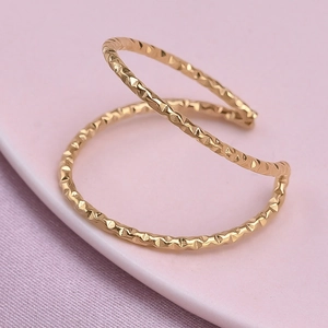 Macro shot of 304 stainless steel gold open double ring with diamond cut texture