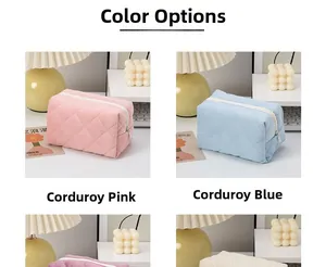 Detail view of pink and blue quilted corduroy makeup bags with metal zipper closure