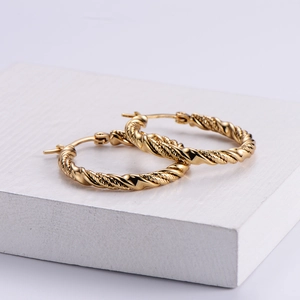 Classic golden titanium steel twisted hoop earrings with elegant textured weave design