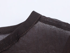 Macro detail of the dark brown chiffon mesh fabric with precise stitching on neckline