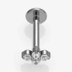 Macro detail of G23 titanium labret stud with three sparkling zircon stones