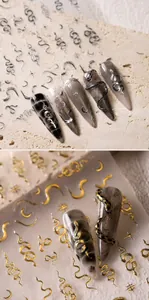 Detail of luxury gold and silver snake nail art stickers with moon and star patterns