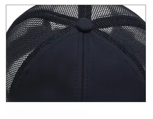Detail shot of black trucker hat crown showing stitching and mesh ventilation