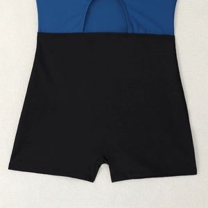 Detailed view of high-waist bikini bottoms with navy blue and black color-block design