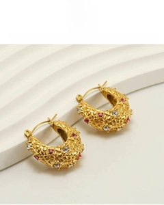Detail of 18k gold plated hoop earring with woven texture and colorful zircon inlays