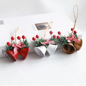 Detail of red white and gold Christmas double bells with pine needles and plaid bows