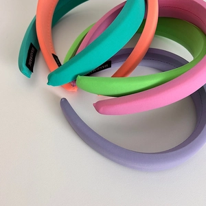 Padded sponge headbands in pastel colors featuring high-crown design and soft knit texture