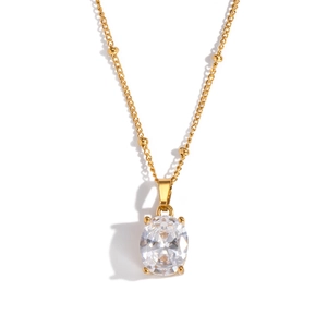 Close-up of gold beaded chain necklace with oval cubic zirconia in four-prong setting