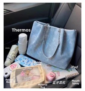 Spacious tote bag capacity display with daily essentials like iPad and water bottle