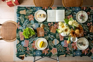 Close-up of green Christmas jacquard tablecloth with festive patterns and woven texture