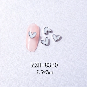 Macro shot of silver edged heart nail charms with white pearlescent inlay 7.5x7mm