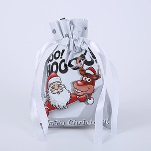 Detail of white Christmas drawstring gift bag with Santa Claus and reindeer print