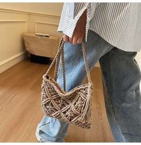 Détail d'un sac bohème tissé avec texture ajourée complexe et pompons décoratifs