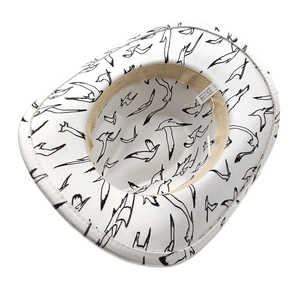 Detail of white cowboy hat interior showing seagull print and 100% polyester label