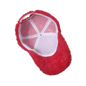 Detailed interior of plush red winter baseball cap showing soft lining and stitching