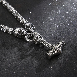 Detail of silver Mjölnir pendant with skull beads on heavy king chain necklace