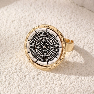 Detailed view of vintage round shield ring with black and white geometric totem pattern