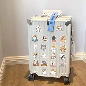 Close-up of cute Japanese cartoon cat stickers on a white aluminum frame suitcase luggage