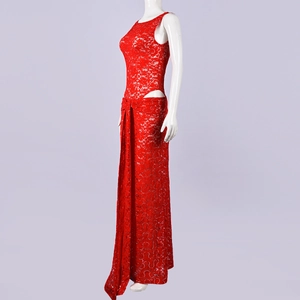 Detail view of red lace dress with sequins and side cutout design on a mannequin