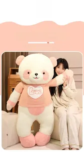Detail of giant panda plush wearing a pink knit sweater with Love heart embroidery